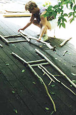 A student laying out the panels of a rustic chair at a workshop with Dan.