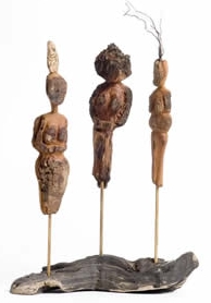 Three figures carved out of bark