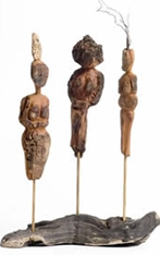 Three figures carved out of bark